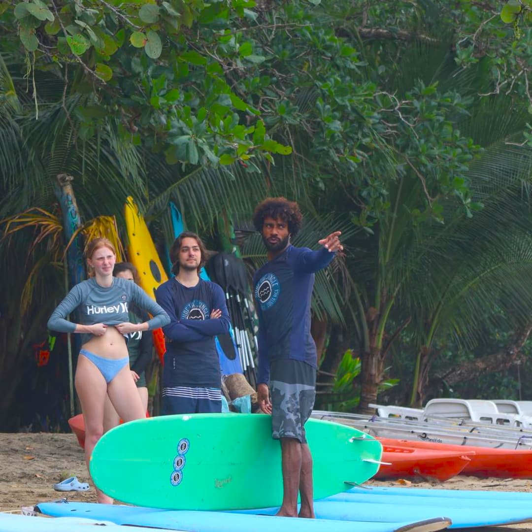 Surfers preparing on a tropical beach.
